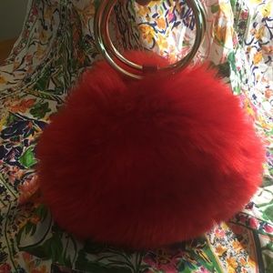 Red fluffy purse with gold ring handles